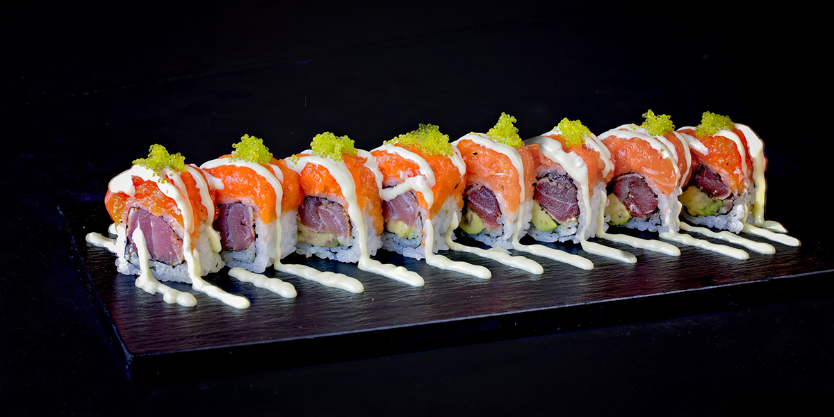 Salmon tuna sushi roll topped with green tobiko and creamy sauce at Komeya Sushi & Ramen, a Japanese Restaurant in Spring