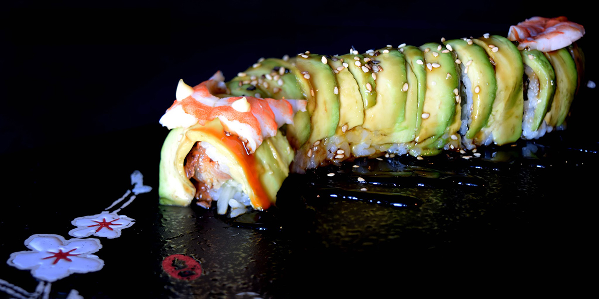 Full avocado wrapped shrimp eel sushi roll with sesame drizzle at Komeya Sushi & Ramen, a Japanese Restaurant in Spring