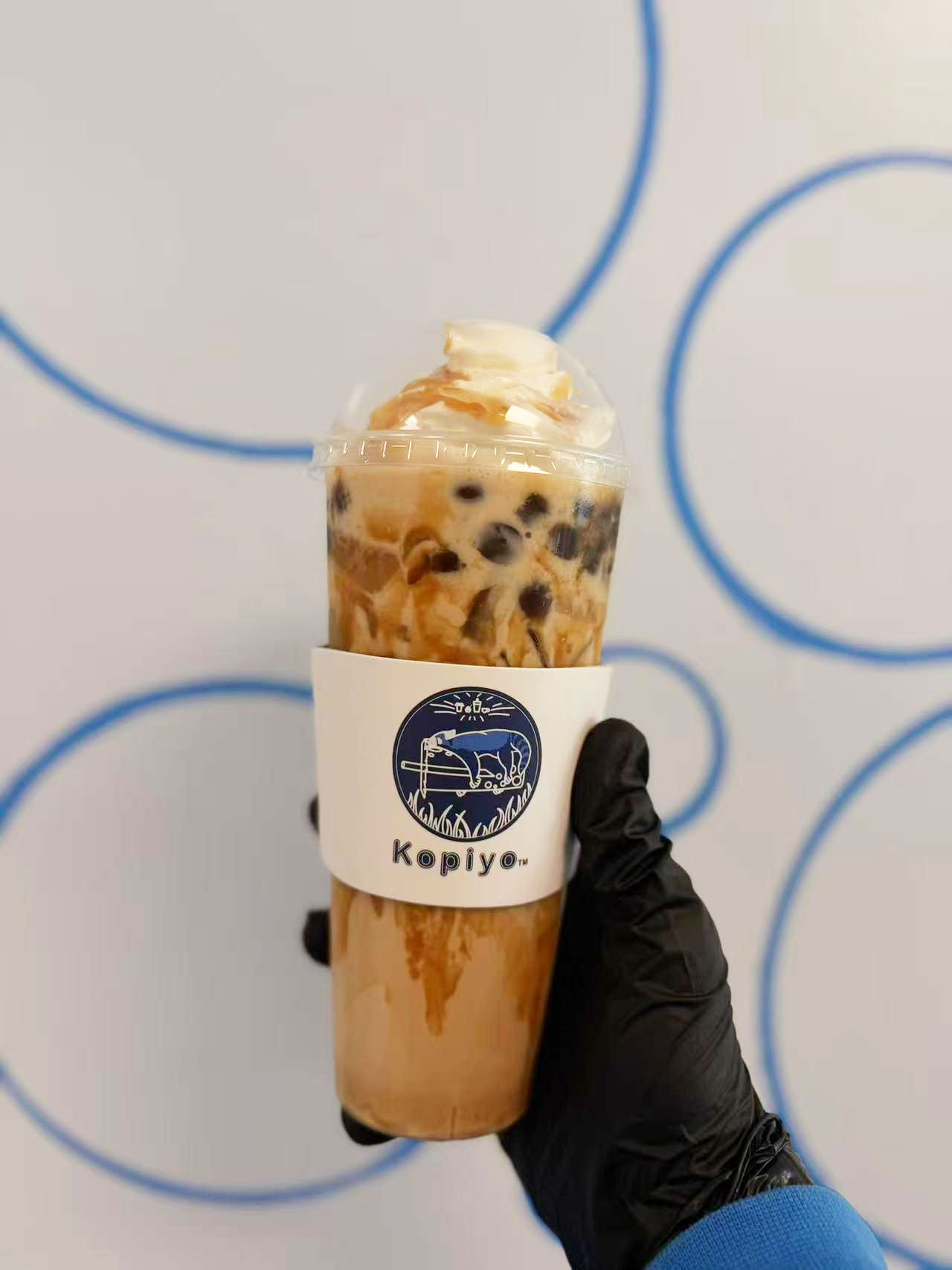 Caramel bubble iced coffee with whipped cream in a Kopiyo cup at Kopiyo, a Coffee shop in Flowood