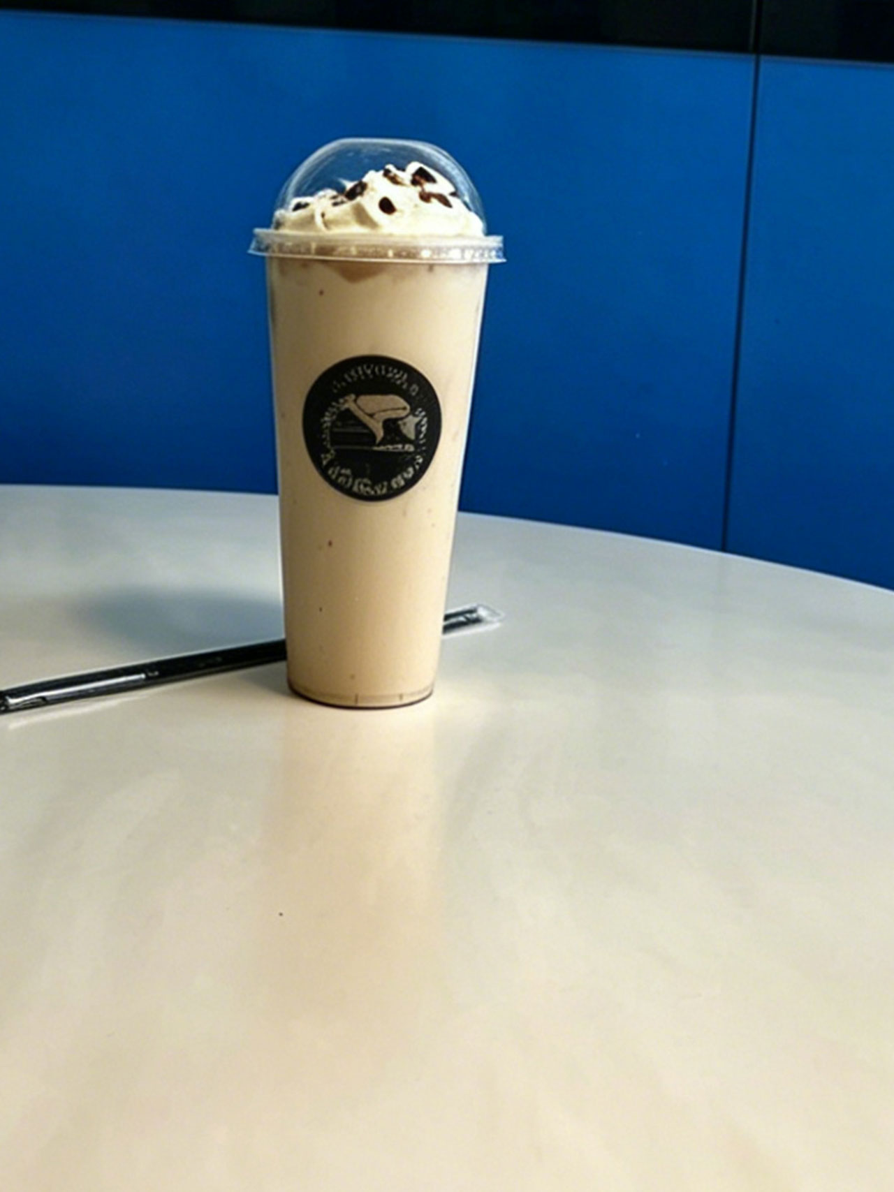 Light beige iced drink with whipped cream and cookie crumbles at Kopiyo, a Coffee shop in Flowood