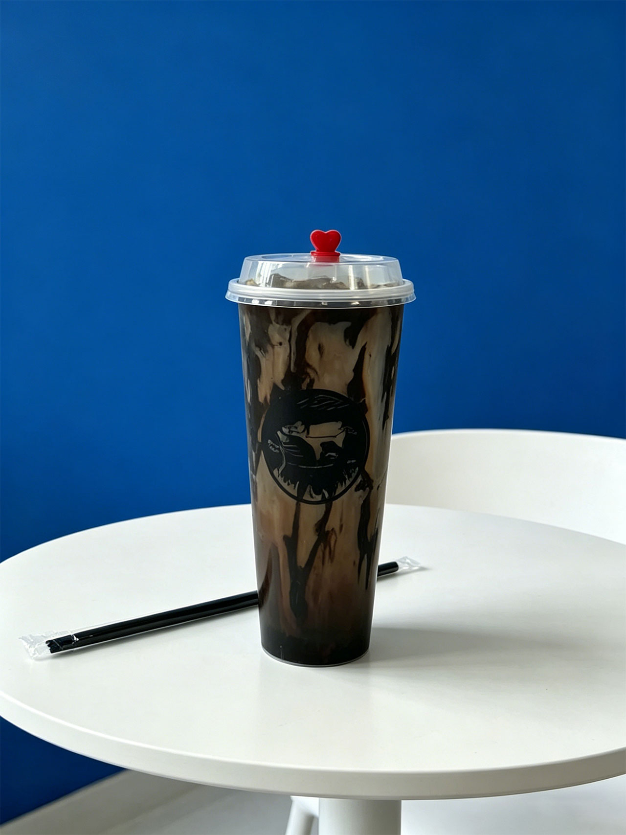Marble-patterned iced coffee in a tall Kopiyo cup with a red heart lid at Kopiyo, a Coffee shop in Flowood