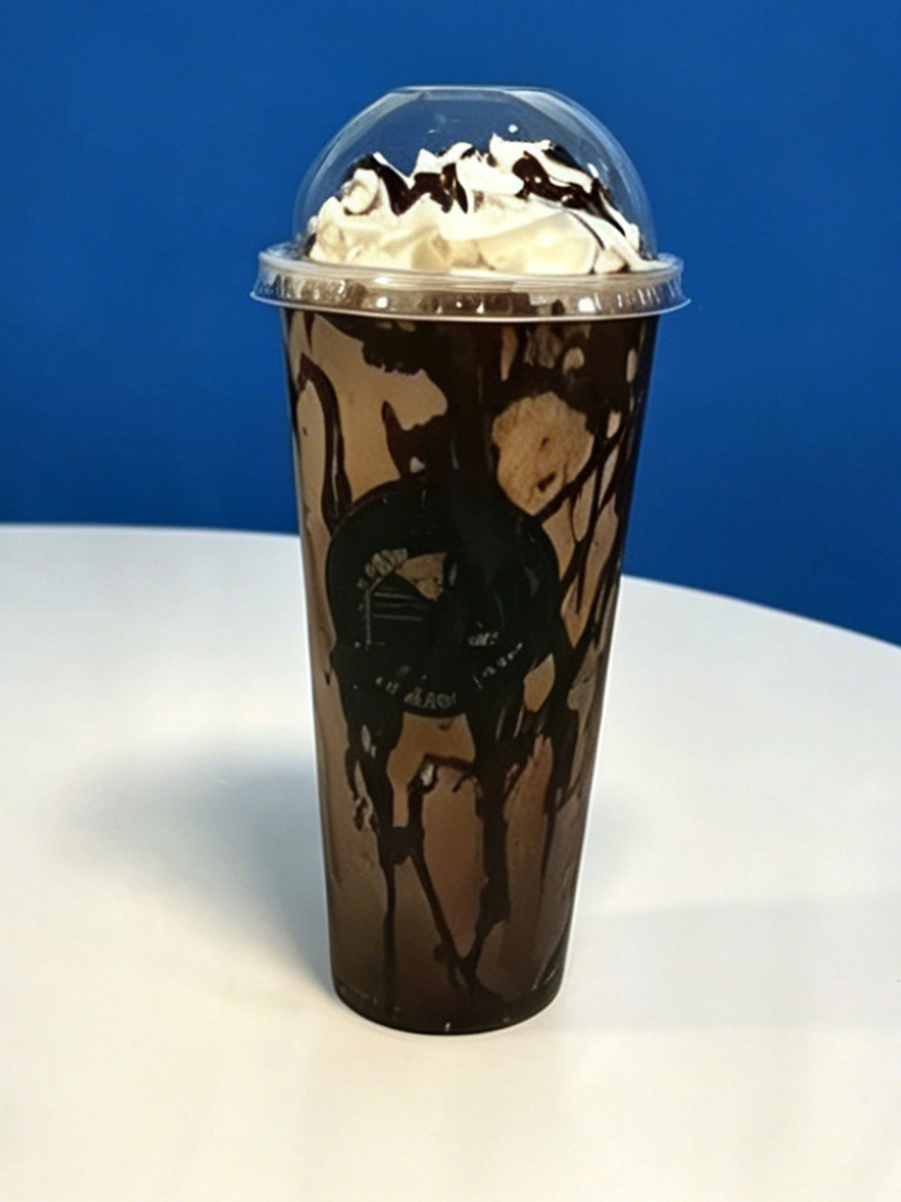 Rich chocolate iced drink with chocolate drizzle and whipped cream at Kopiyo, a Coffee shop in Flowood
