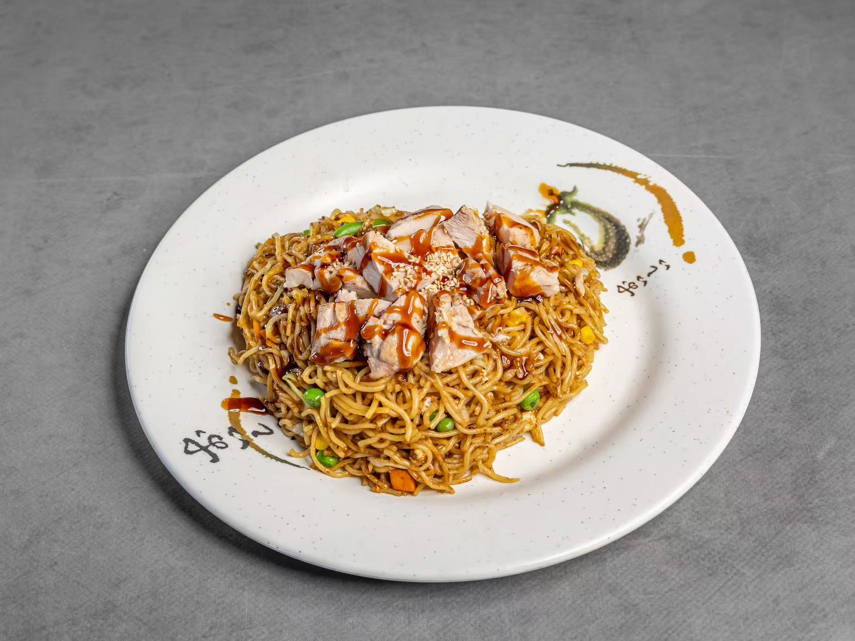 Chicken yakisoba with vegetables, topped with chicken and teriyaki sauce at Koya Sushi, a Sushi Restaurant in Norco