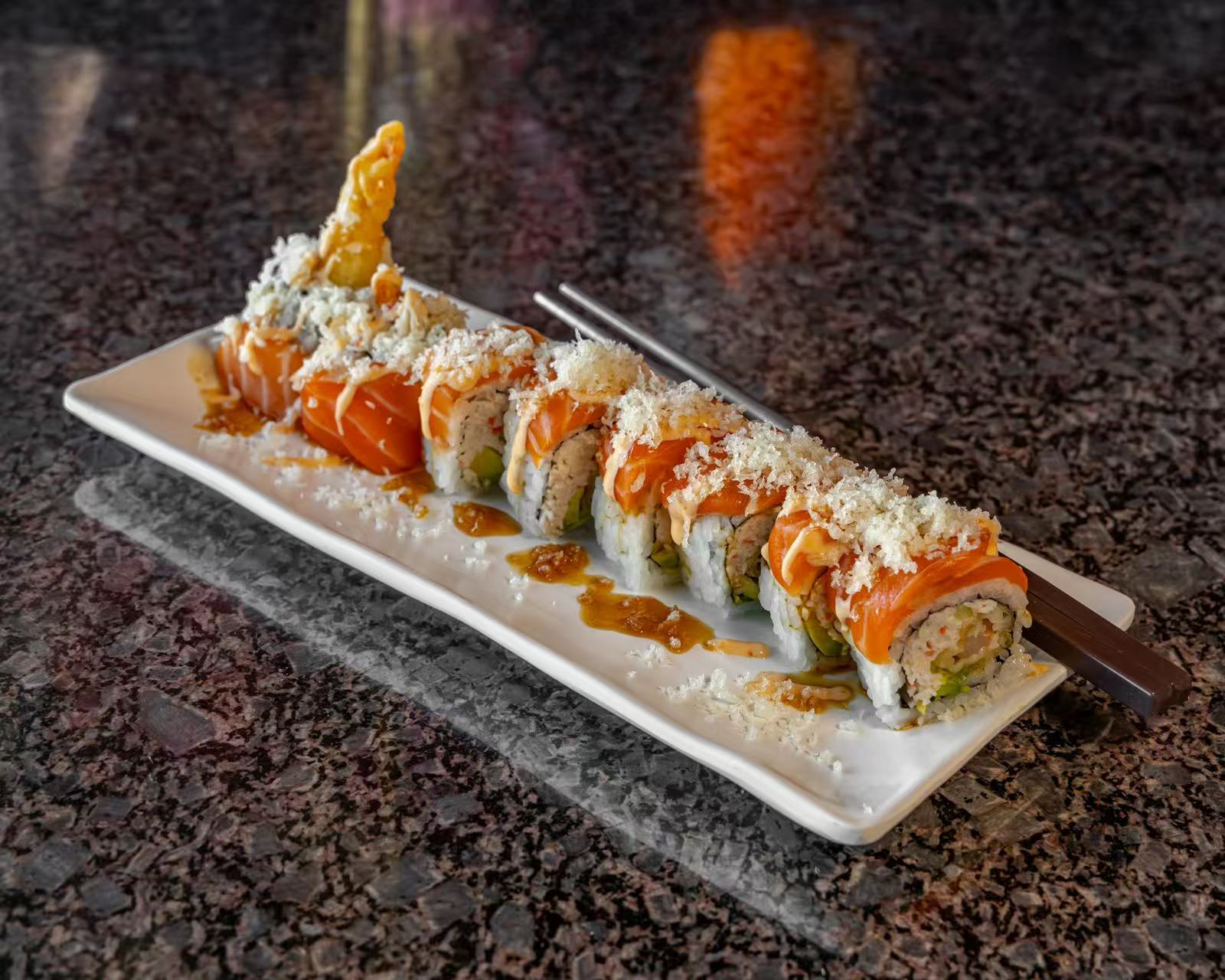 A sushi roll with shrimp tempura, topped with salmon and crispy flakes at Koya Sushi, a Sushi Restaurant in Norco