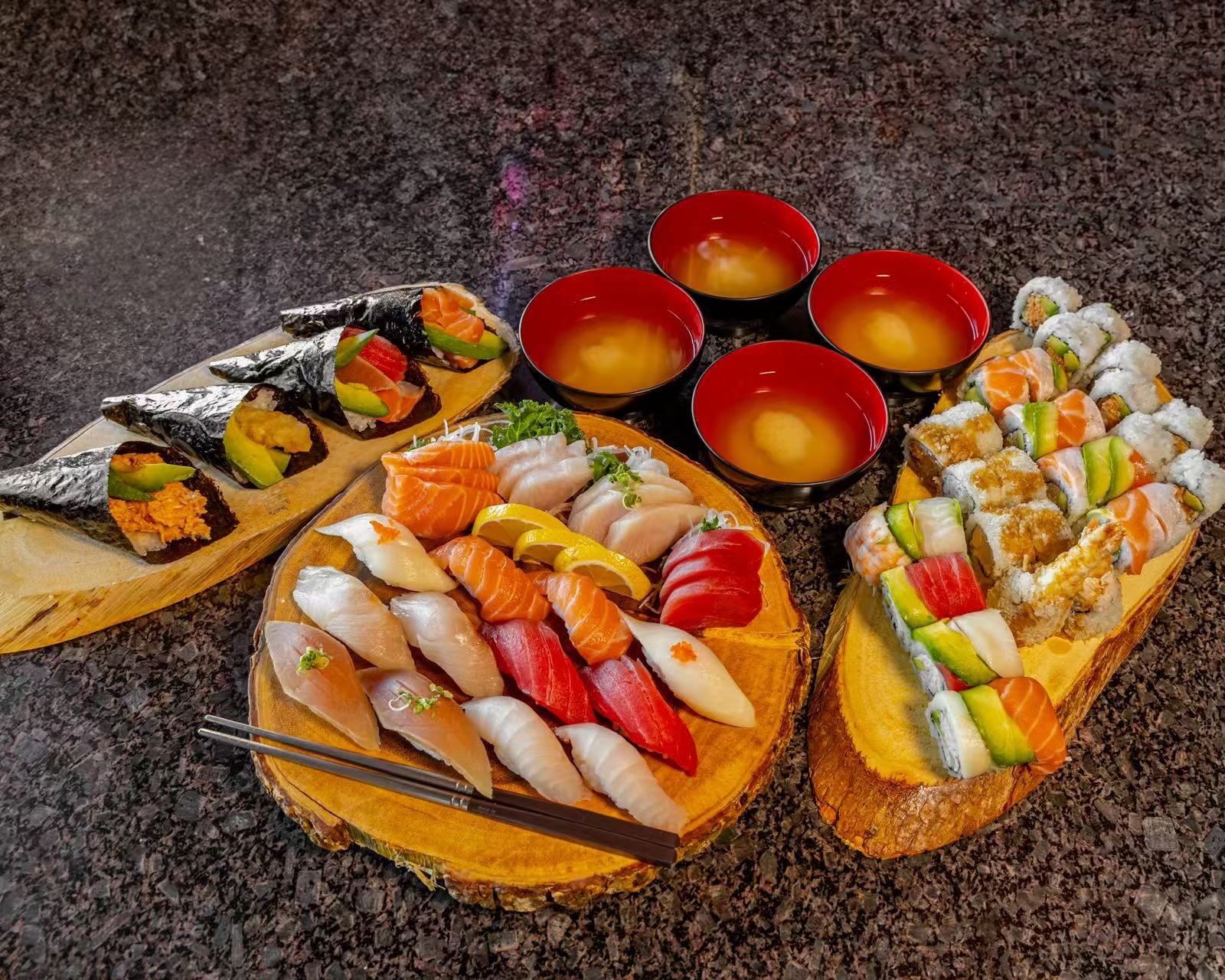 A platter of sushi, sashimi, hand rolls, and four bowls of miso soup at Koya Sushi, a Sushi Restaurant in Norco