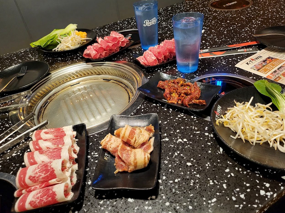 Various barbecue ingredients, including raw meat and vegetables at K-Town Korean BBQ & Hotpot, a Korean BBQ & Hotpot Restaurant in Fort Wayne