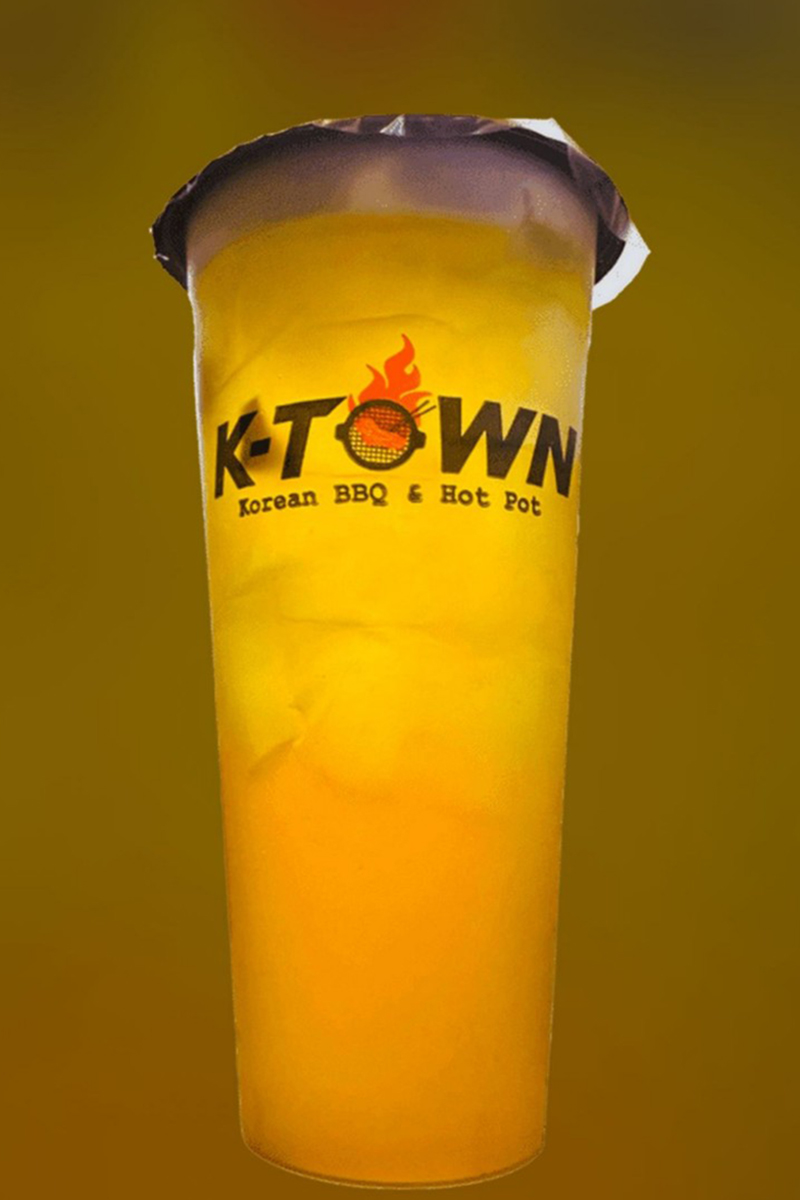 A cup of orange drink with the word "KTOWN" on the cup at K-Town Korean BBQ & Hotpot, a Korean BBQ & Hotpot Restaurant in Fort Wayne