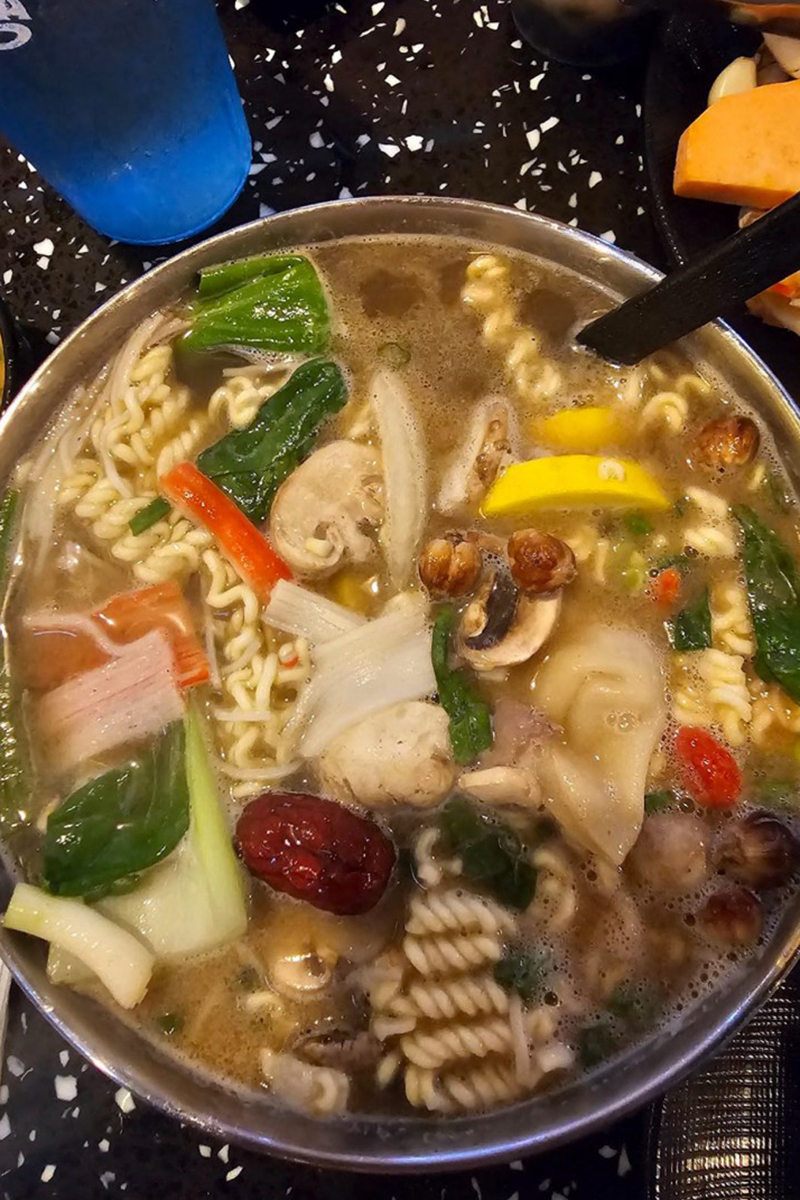 The pot is rich in ingredients, including vegetables, meat, fungi, etc., with a rich soup at K-Town Korean BBQ & Hotpot, a Korean BBQ & Hotpot Restaurant in Fort Wayne