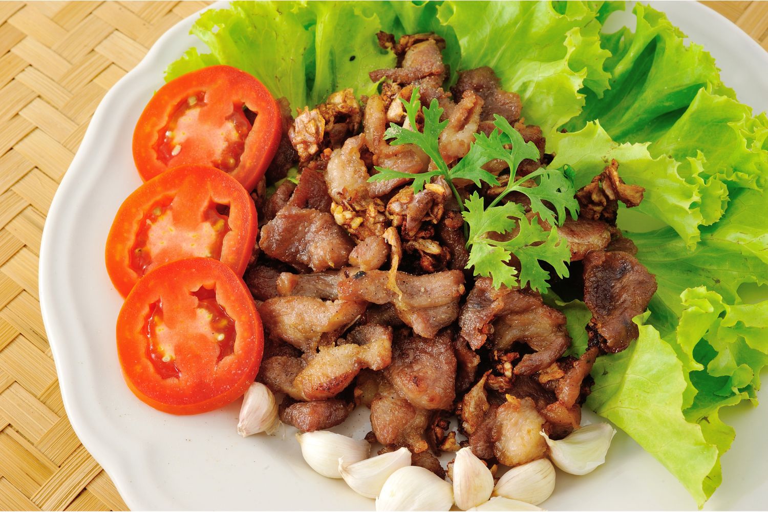 Fried pork belly with lettuce, tomatoes and garlic at K-town Korean BBQ Restaurant in Hemet