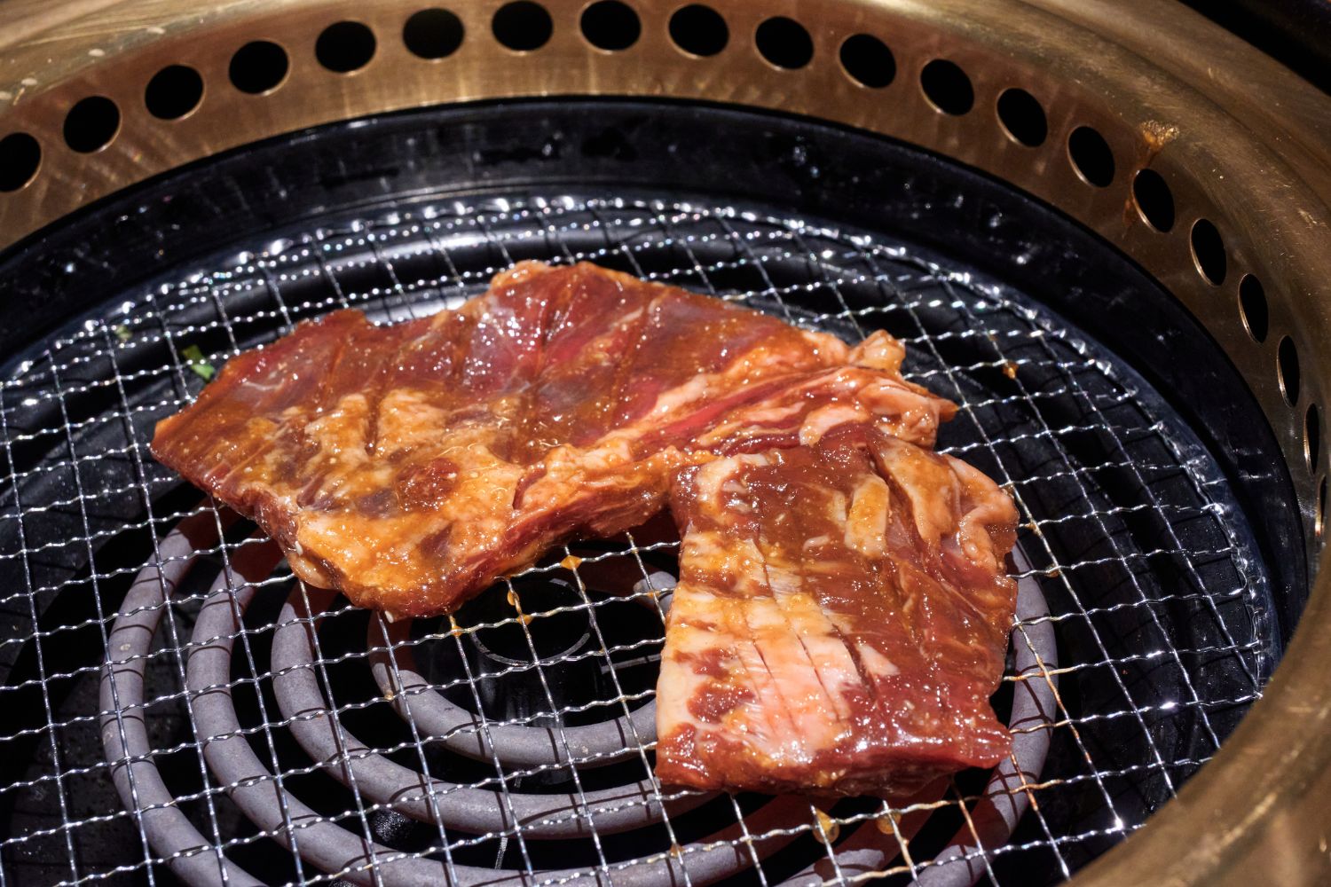 Marinated beef ribs grilling on the BBQ grill at K-town Korean BBQ Restaurant in Hemet