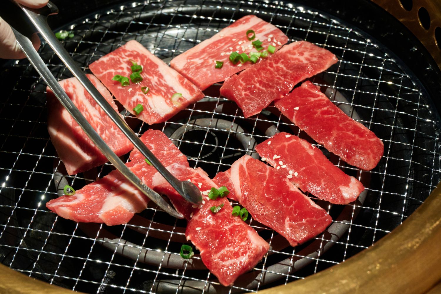 Fresh beef slices grilling with green onions at K-town Korean BBQ Restaurant in Hemet