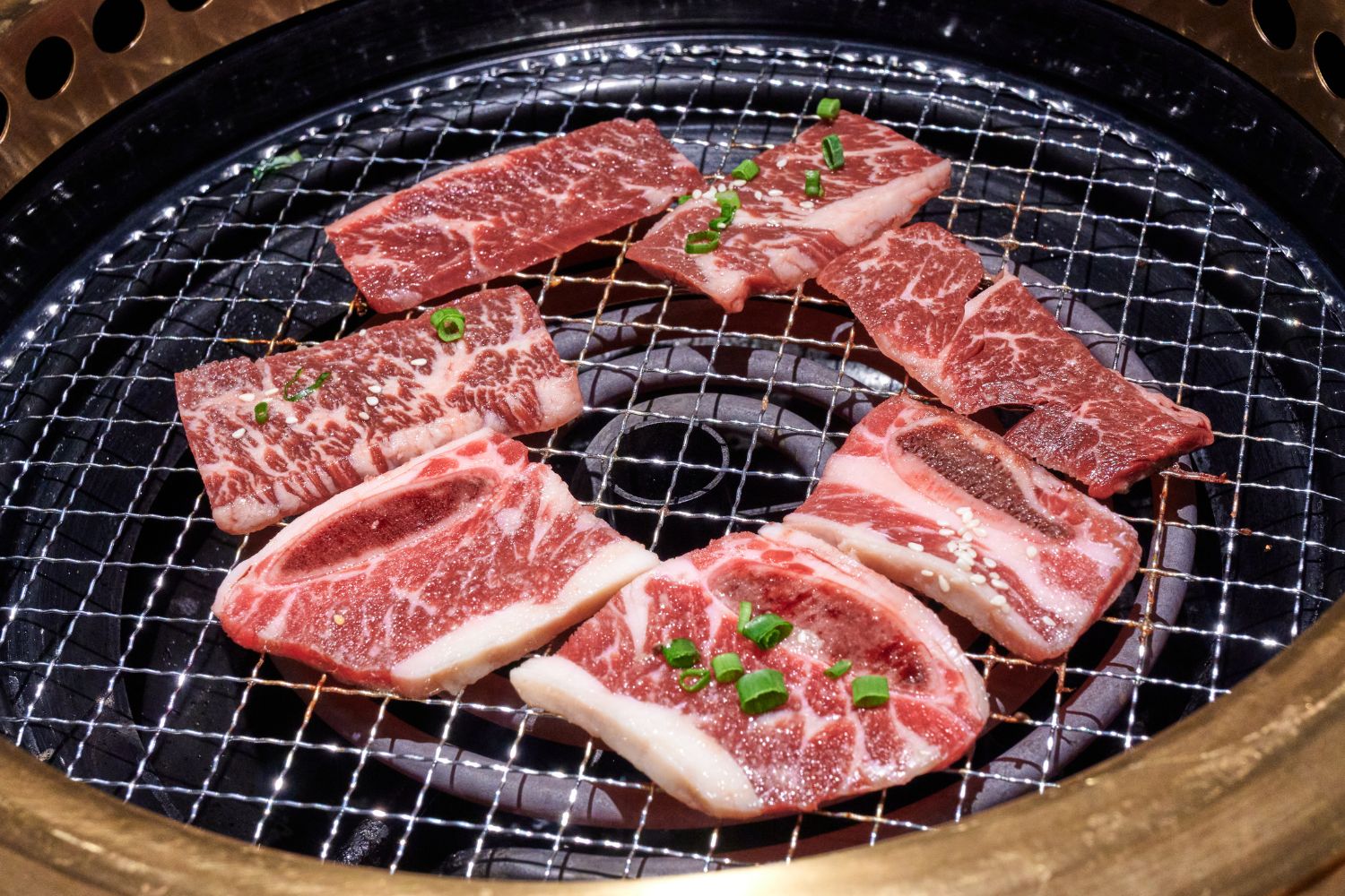 Marbled beef short ribs grilling on the BBQ at K-town Korean BBQ Restaurant in Hemet