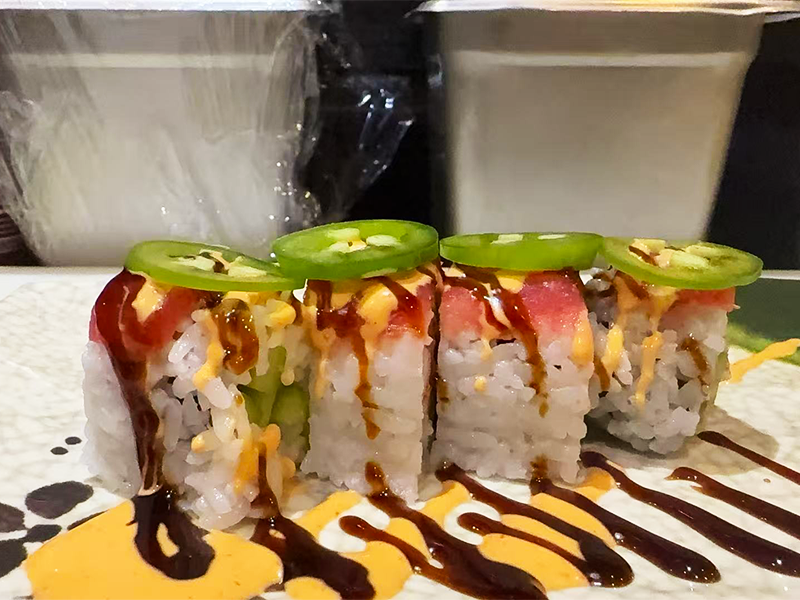 Spicy tuna roll topped with jalapeño slices at Kublai Khan Crazy Mongolian Stir Fry & Sushi Bar, a Asian Restaurant in Austin