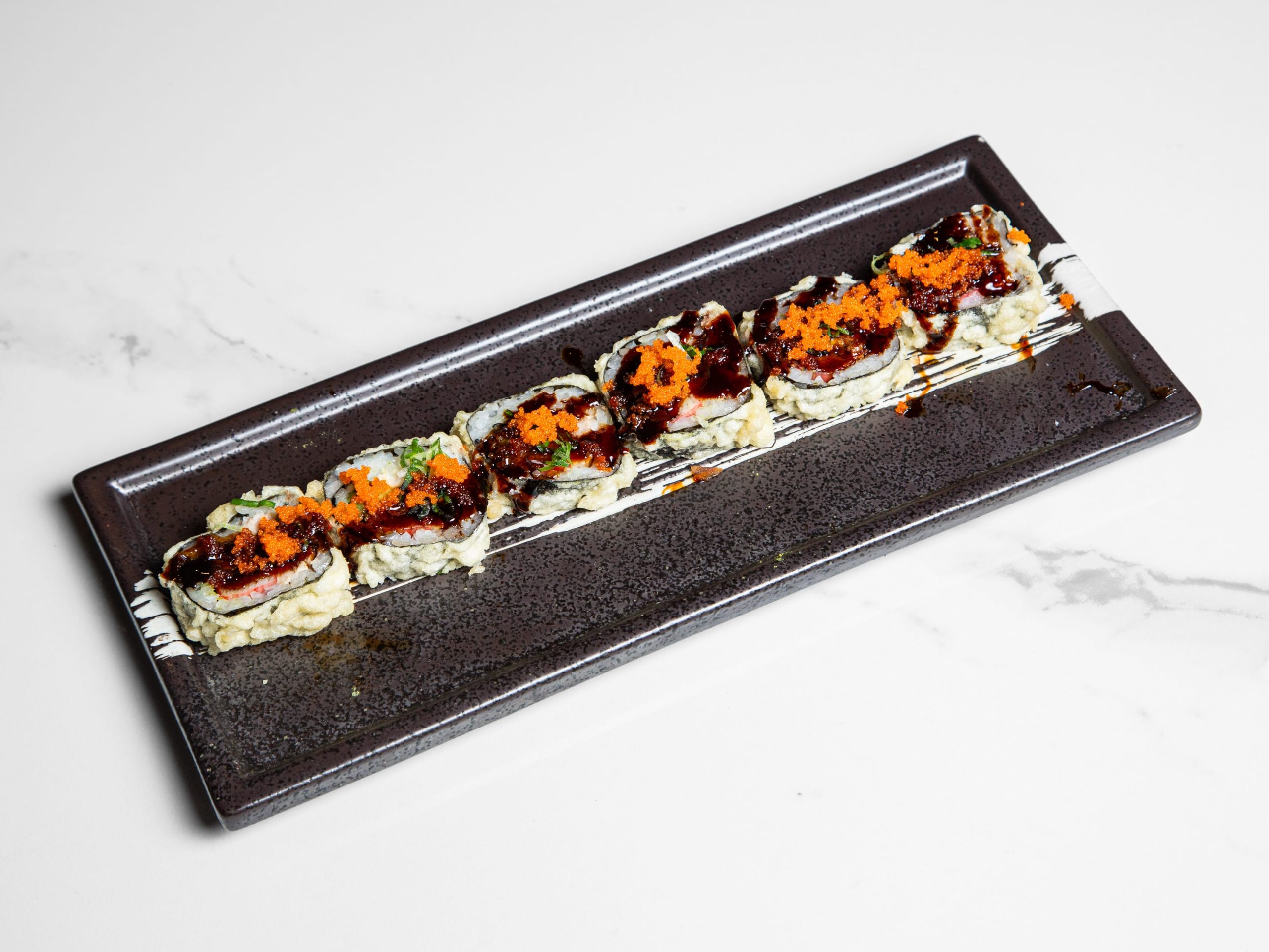 Sushi roll with assorted seafood and spicy sauce at Kuchi, a Buffet Restaurant in Tampa