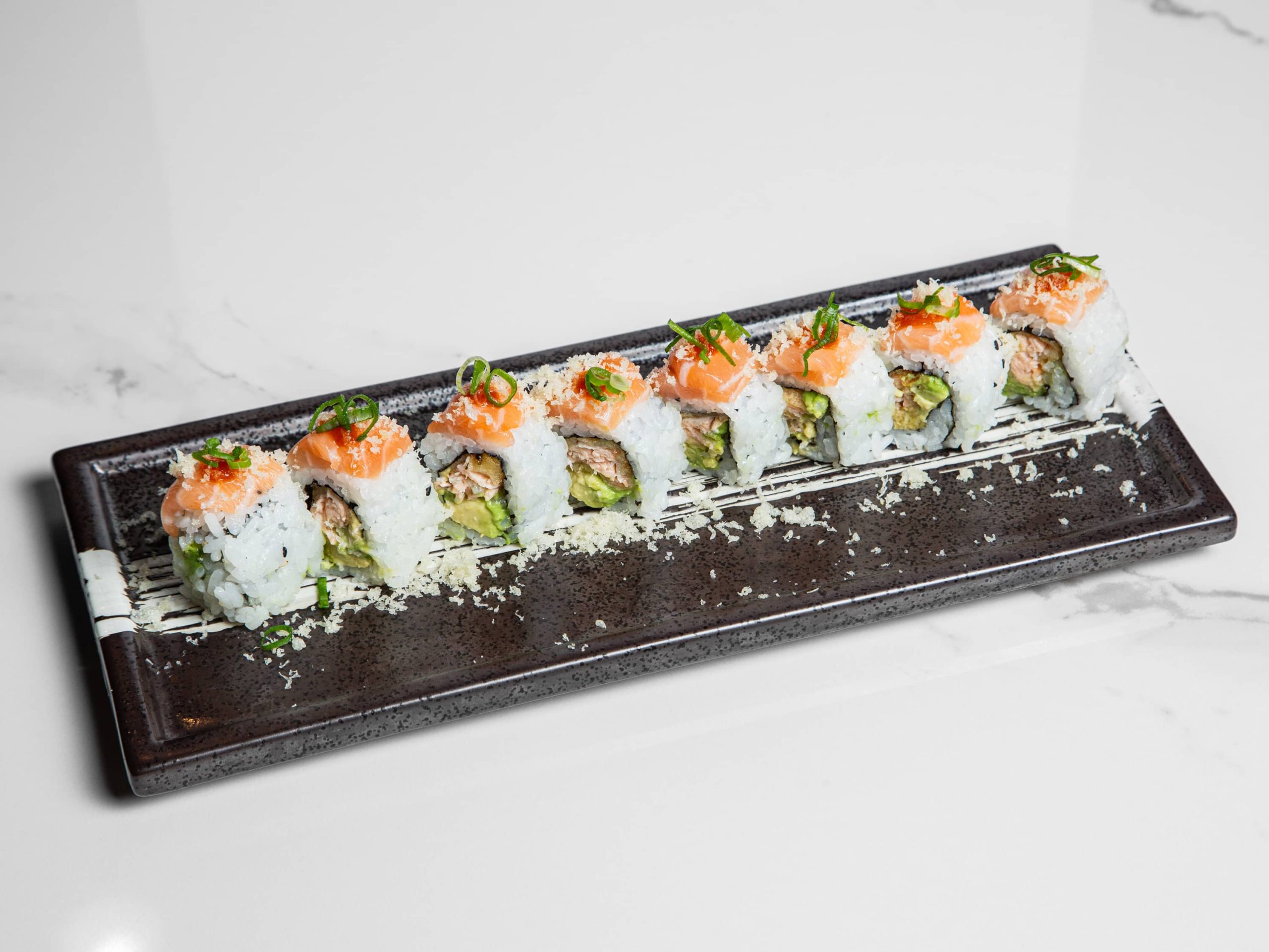 Bright sushi roll with assorted fish and avocado at Kuchi, a Buffet Restaurant in Tampa