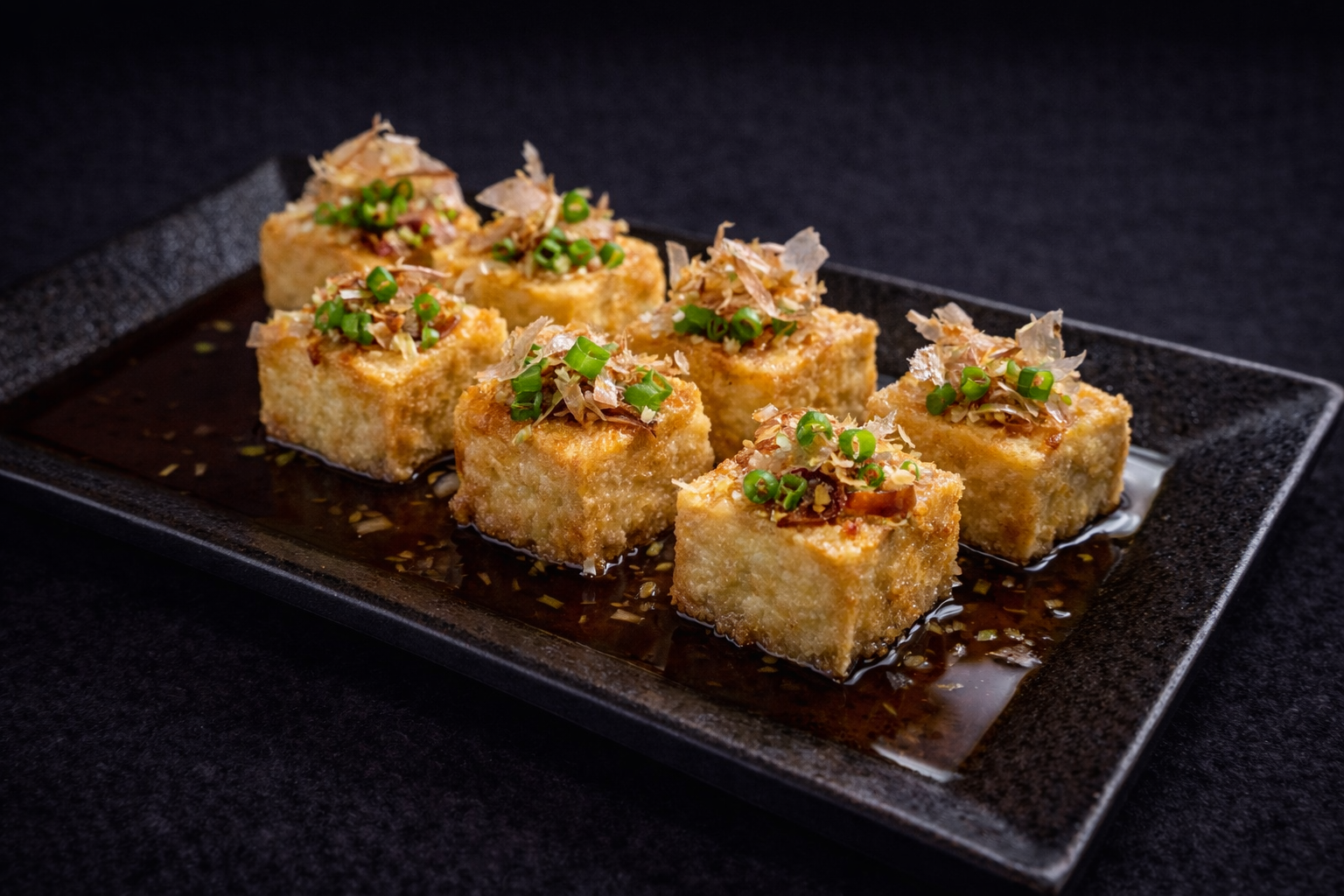 Pan-fried tofu cubes with bonito flakes and scallions at Kuchi buffet, a Sushi restaurant in Tampa