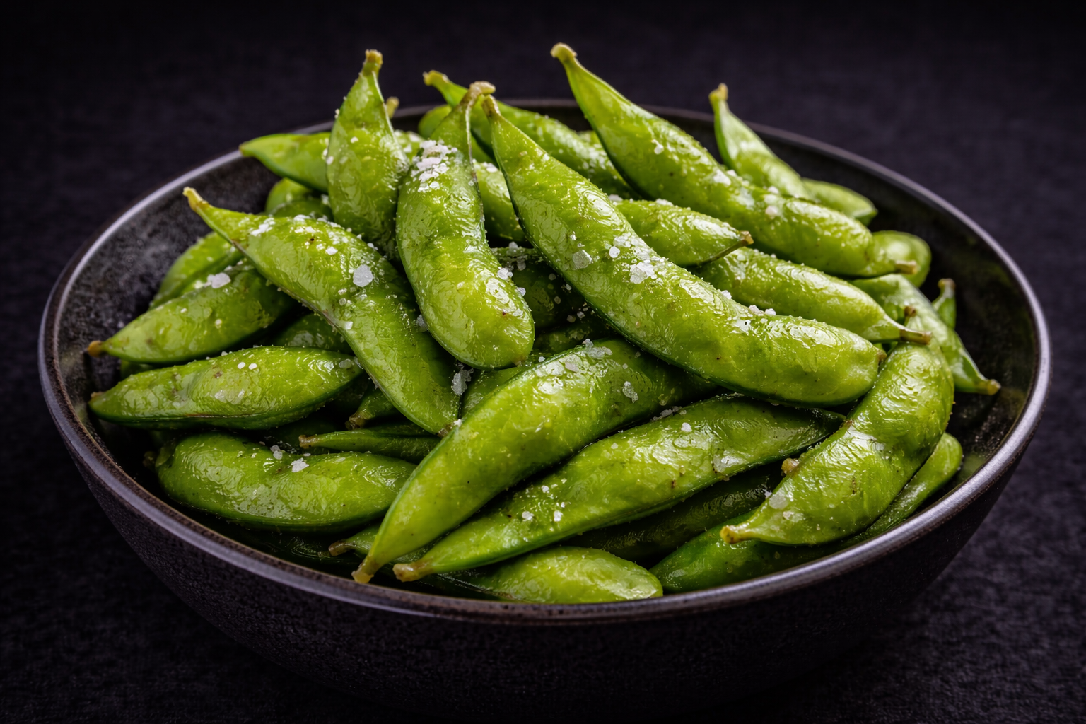 Salted edamame in a black bowl at Kuchi buffet, a Sushi restaurant in Tampa