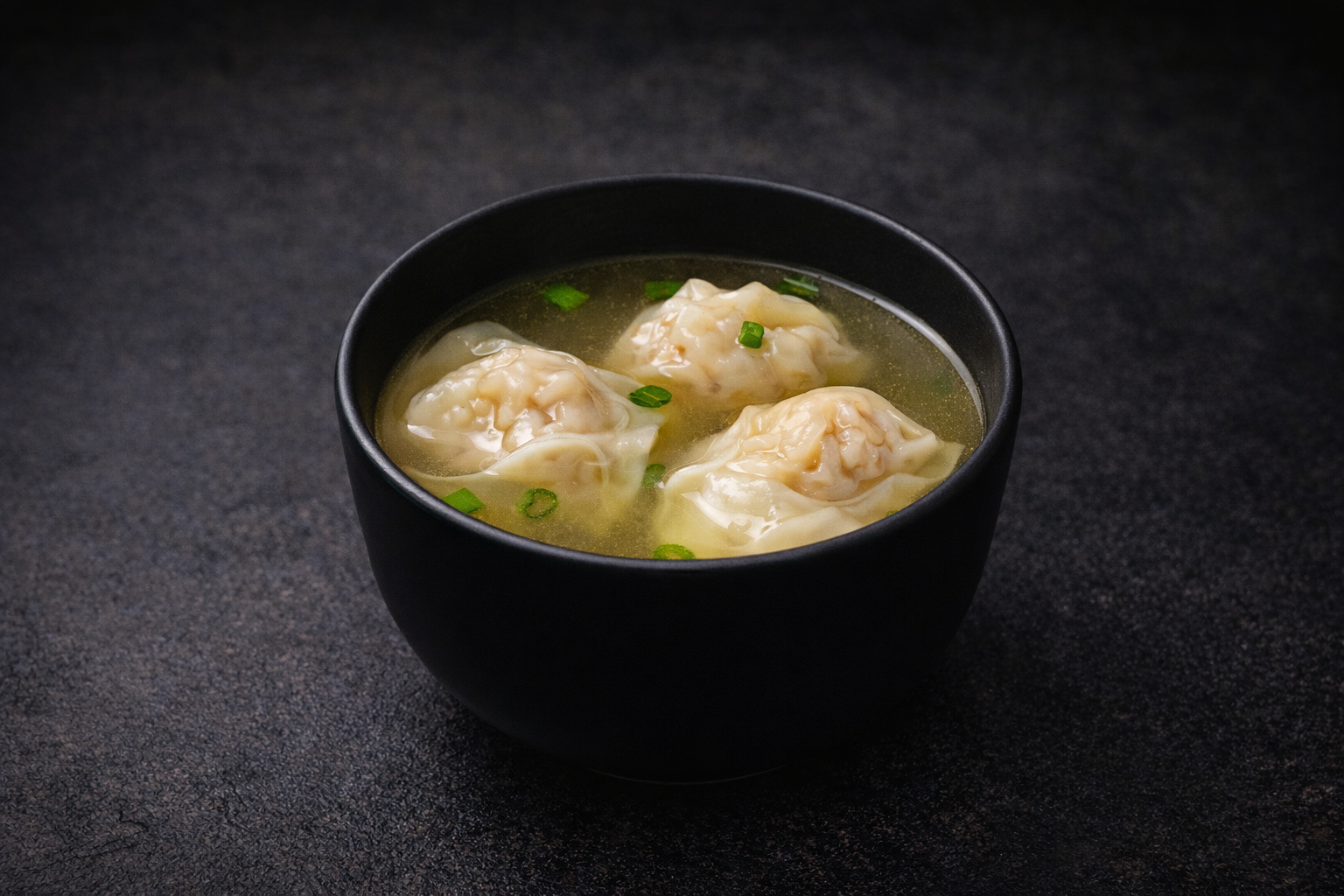 Soup wontons with scallions in black bowl at Kuchi buffet, a Sushi restaurant in Tampa