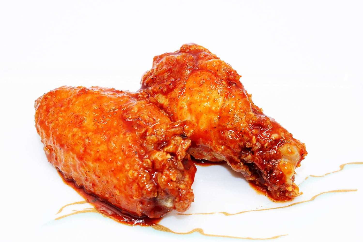 Spicy glazed fried chicken wings on a white plate at Kumamon Sushi & Ramen AYCE, a Japanese Restaurant in Wilmington