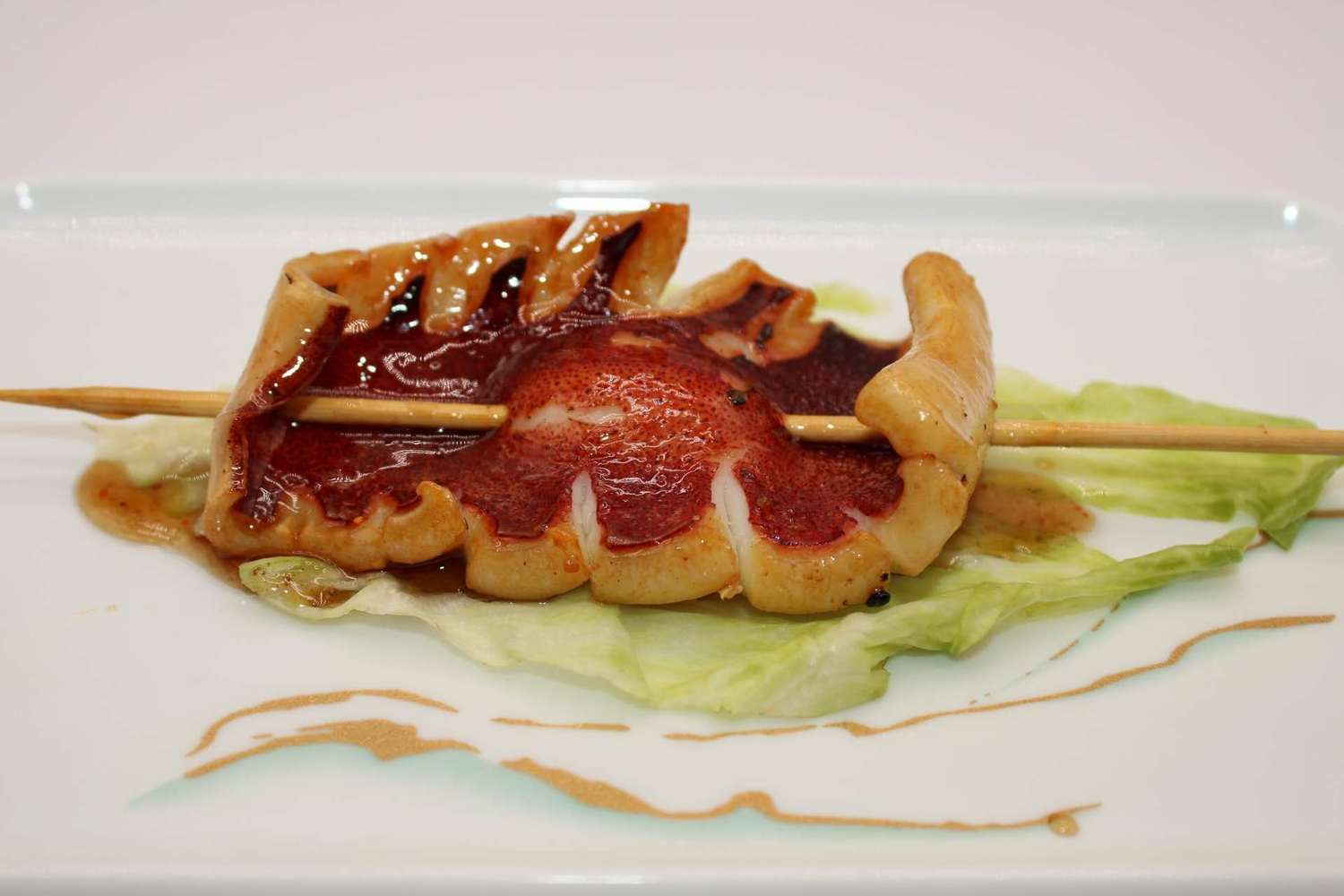 Grilled octopus skewer glazed with savory sauce at Kumamon Sushi & Ramen AYCE, a Japanese Restaurant in Wilmington