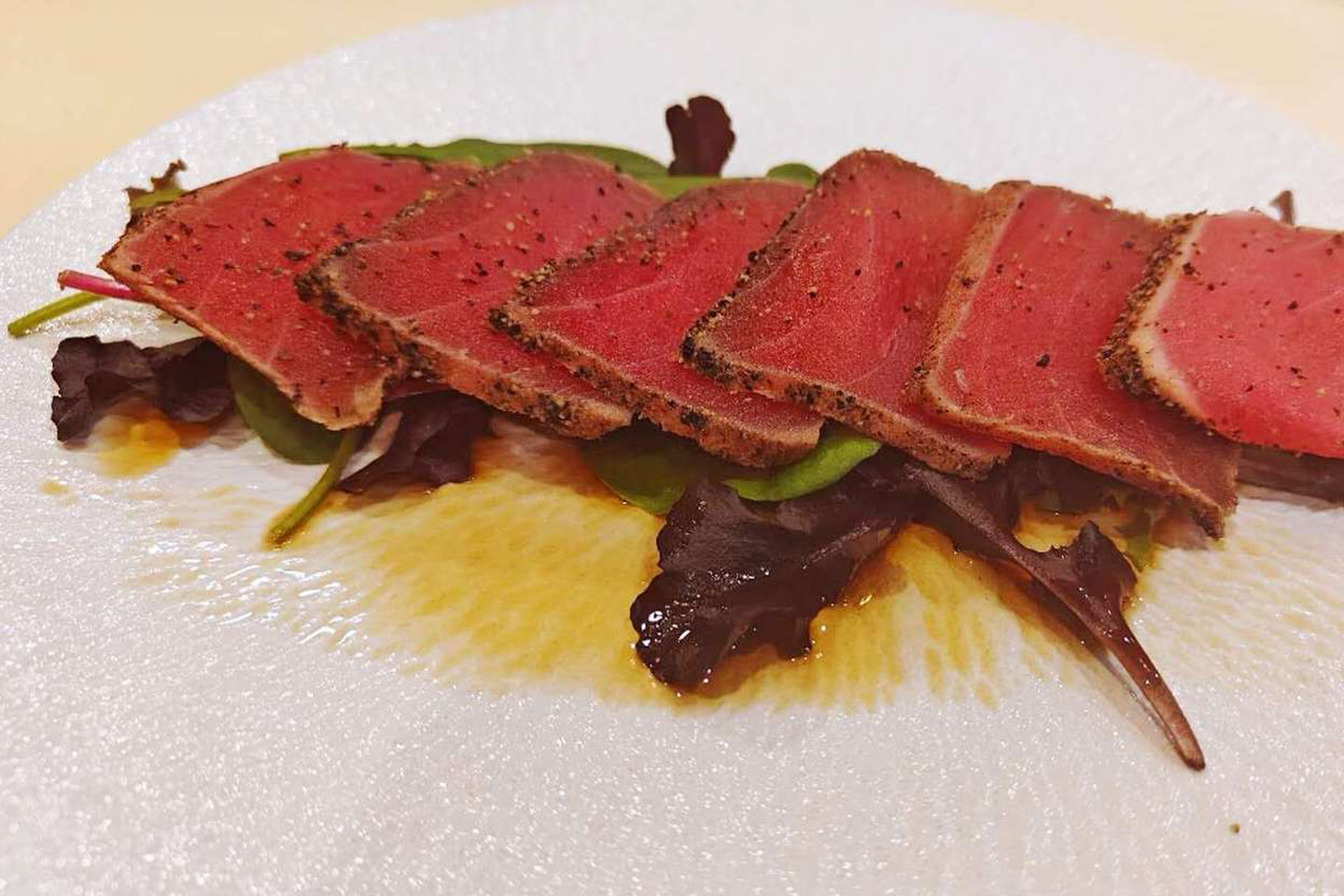 Seared tuna slices with mixed greens and dressing at Kumamon Sushi & Ramen AYCE, a Japanese Restaurant in Wilmington