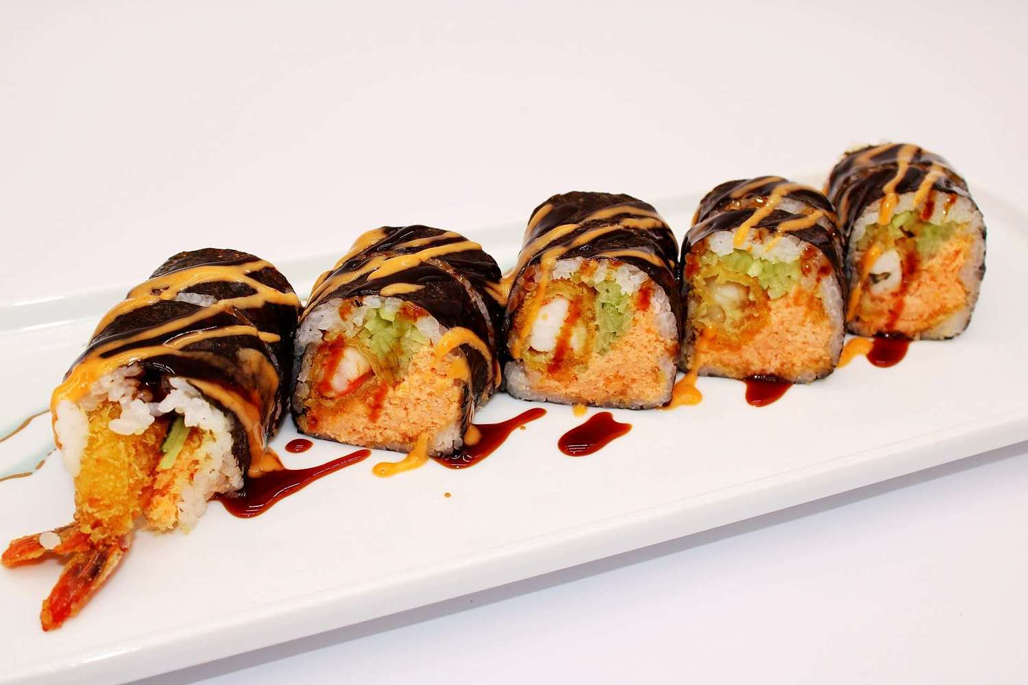 Shrimp tempura sushi roll drizzled with sweet and spicy sauces at Kumamon Sushi & Ramen AYCE, a Japanese Restaurant in Wilmington
