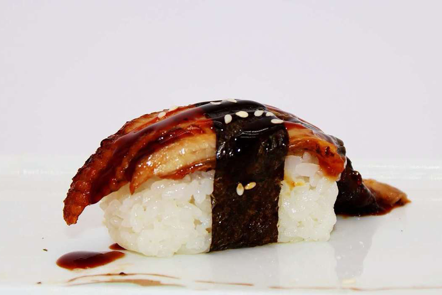 Unagi eel nigiri with teriyaki sauce and sesame seeds at Kumamon Sushi & Ramen AYCE, a Japanese Restaurant in Wilmington
