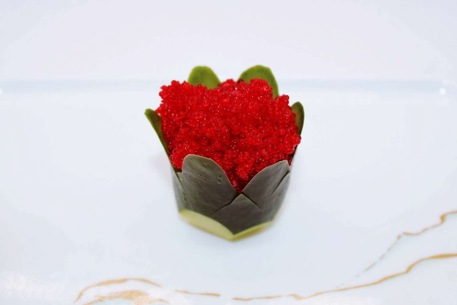 Cucumber cup filled with vibrant red tobiko roe at Kumamon Sushi & Ramen AYCE, a Japanese Restaurant in Wilmington