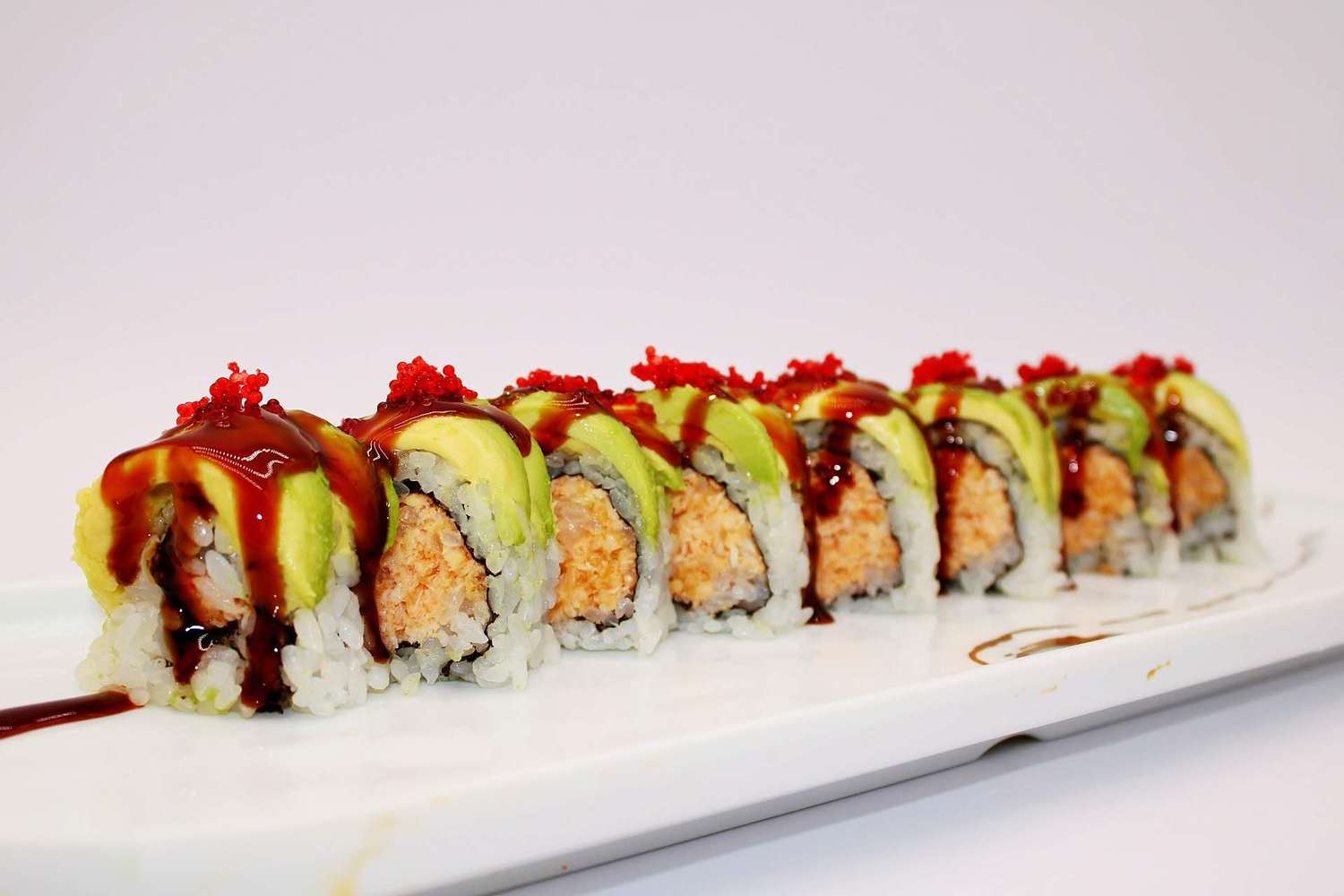 Avocado sushi rolls with tobiko and unagi sauce at Kumamon Sushi & Ramen AYCE, a Japanese Restaurant in Wilmington
