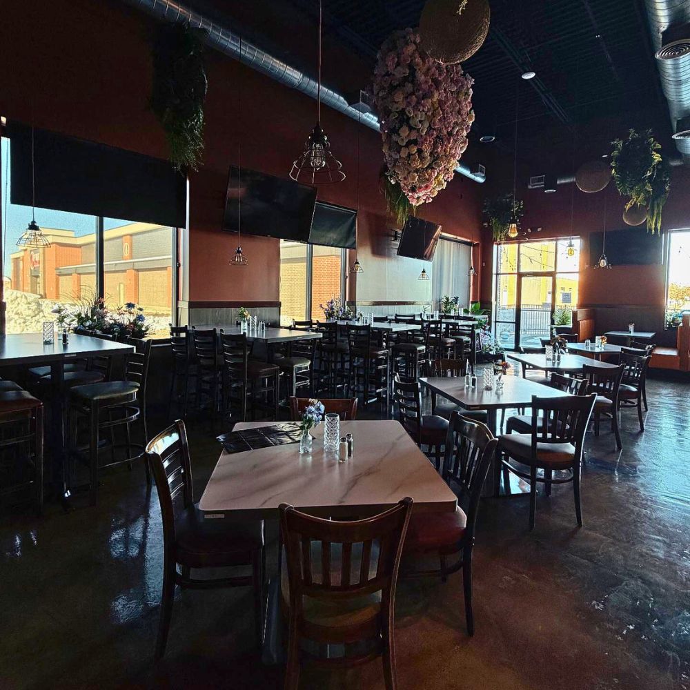 Interior dining area with tables and floral decor at Kumo, a Japanese Restaurant in Schererville