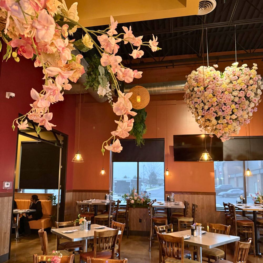Dining room with hanging floral installations at Kumo, a Japanese Restaurant in Schererville
