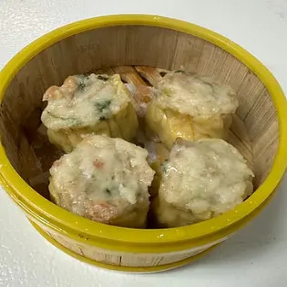 Four seafood siu mai in yellow bamboo steamer