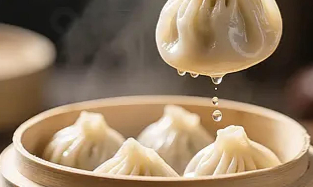 Steamed soup dumplings dripping broth in a bamboo steamer at Kung Fu Noodle House, a Chinese restaurant in West Allis