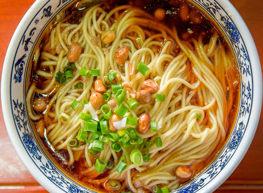 Spicy noodles with peanuts, scallions in dark broth at Kungfu Noodles, a Ramen restaurant in Port Hueneme