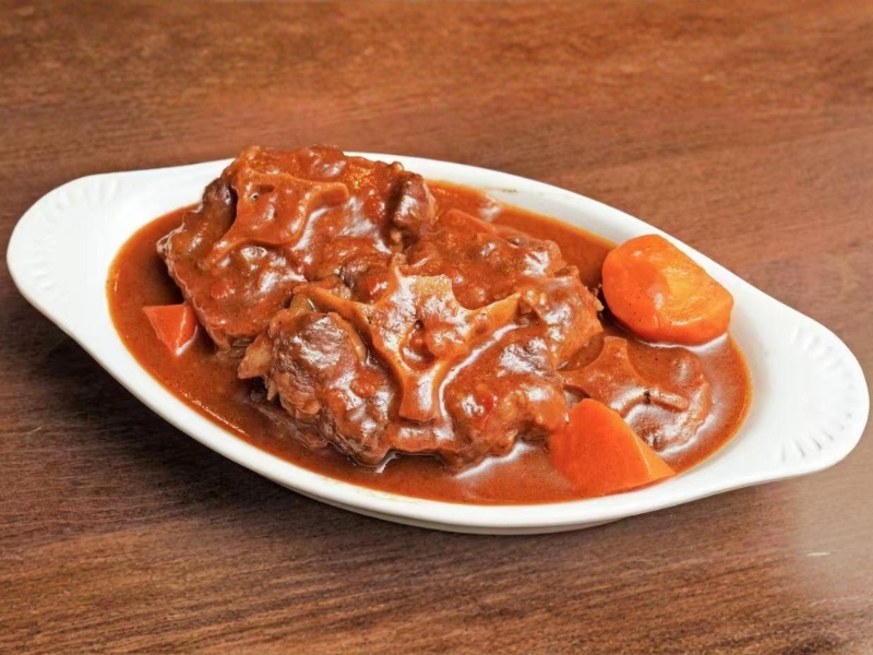 Beef stew with carrots in sauce at La Caridad 72, a Asian Restaurant in New York