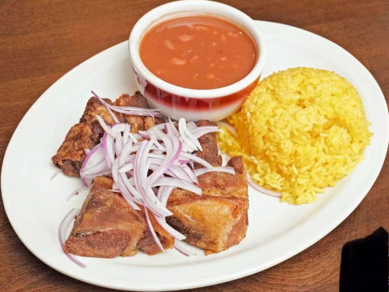Fried pork, yellow rice and beans at La Caridad 72, a Asian Restaurant in New York