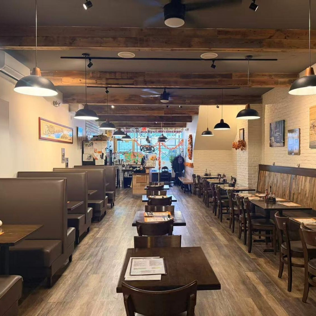 Spacious dining area with booths and tables at La Caridad 72, a Asian Restaurant in New York