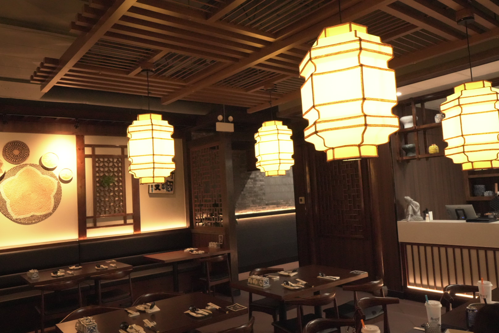 Interior dining area with lanterns and wooden decor at Lao Hu Tong, a Asian Restaurant in Schaumburg