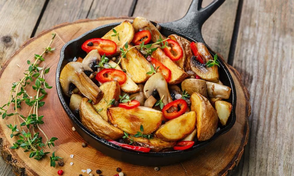 Roasted potato wedges with mushrooms, chili, and thyme in a cast iron skillet at Legend Asian Fusion, a Asian fusion restaurant in Colonia