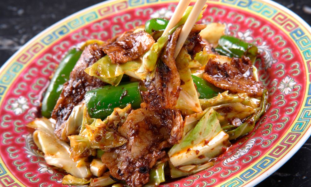 Stir-fried pork with cabbage and green peppers in a savory sauce at Legend Asian Fusion, a Asian fusion restaurant in Colonia