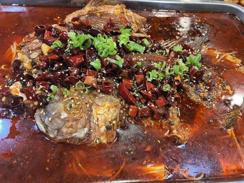 Liao-M-BBQ-Chinese-restaurant-Spicy-Hot-Pot-Fish-Flushing Spicy Hot - Pot Fish - Whole fish in a spicy hot - pot sauce garnished with scallions at Liao M BBQ, a Chinese restaurant in Flushing