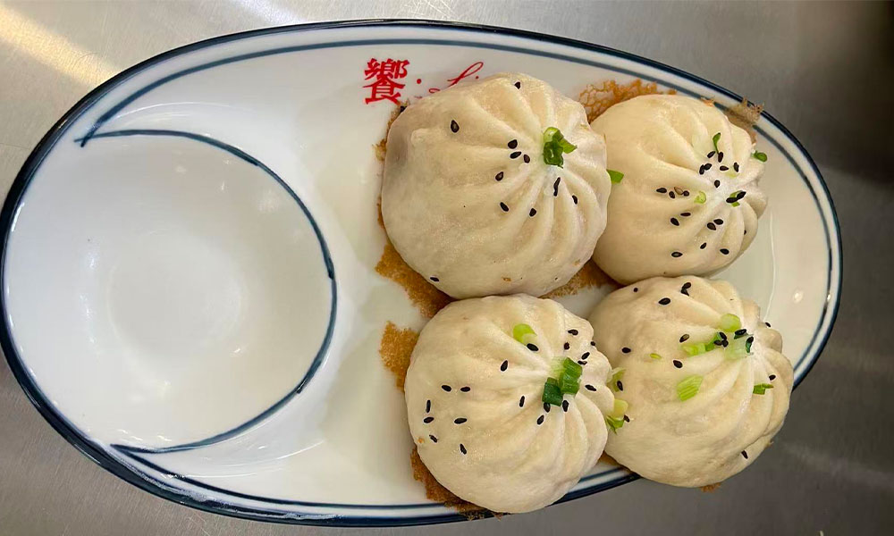 Golden pan-fried buns topped with sesame & scallions at Licious Noodles & Bao, a Chinese Dumpling Restaurant in Rockledge