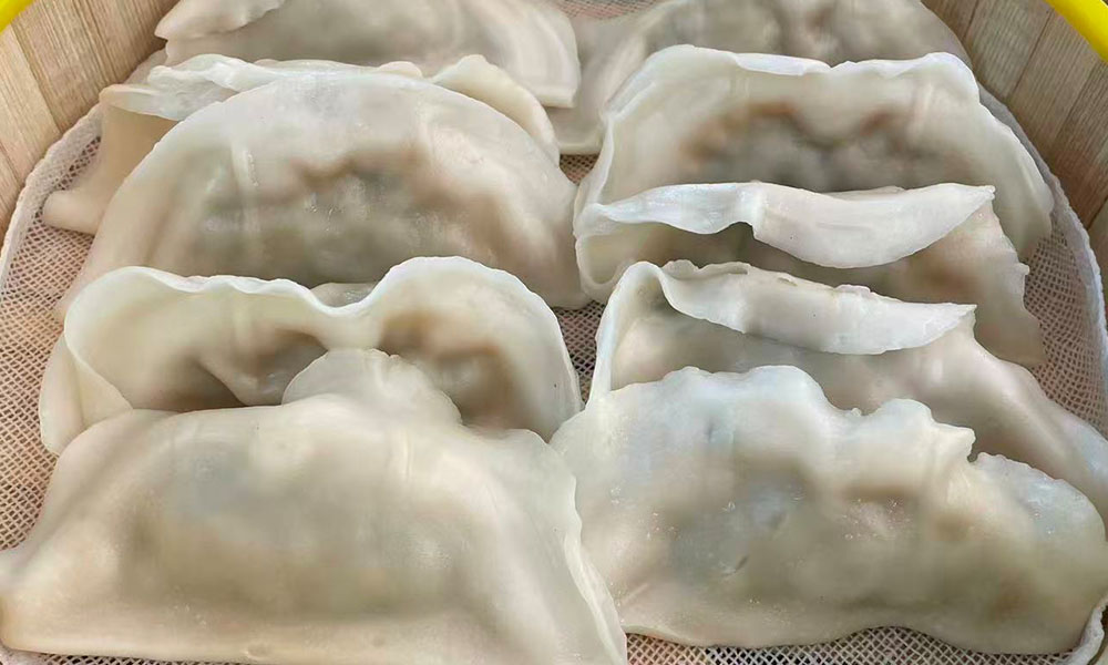 Plump chive-filled steamed dumplings in bamboo steamer at Licious Noodles & Bao, a Chinese Dumpling Restaurant in Rockledge
