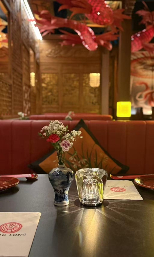 Styled dining table with vase and branded items at Ling Long, a Asian Restaurant in Oklahoma City