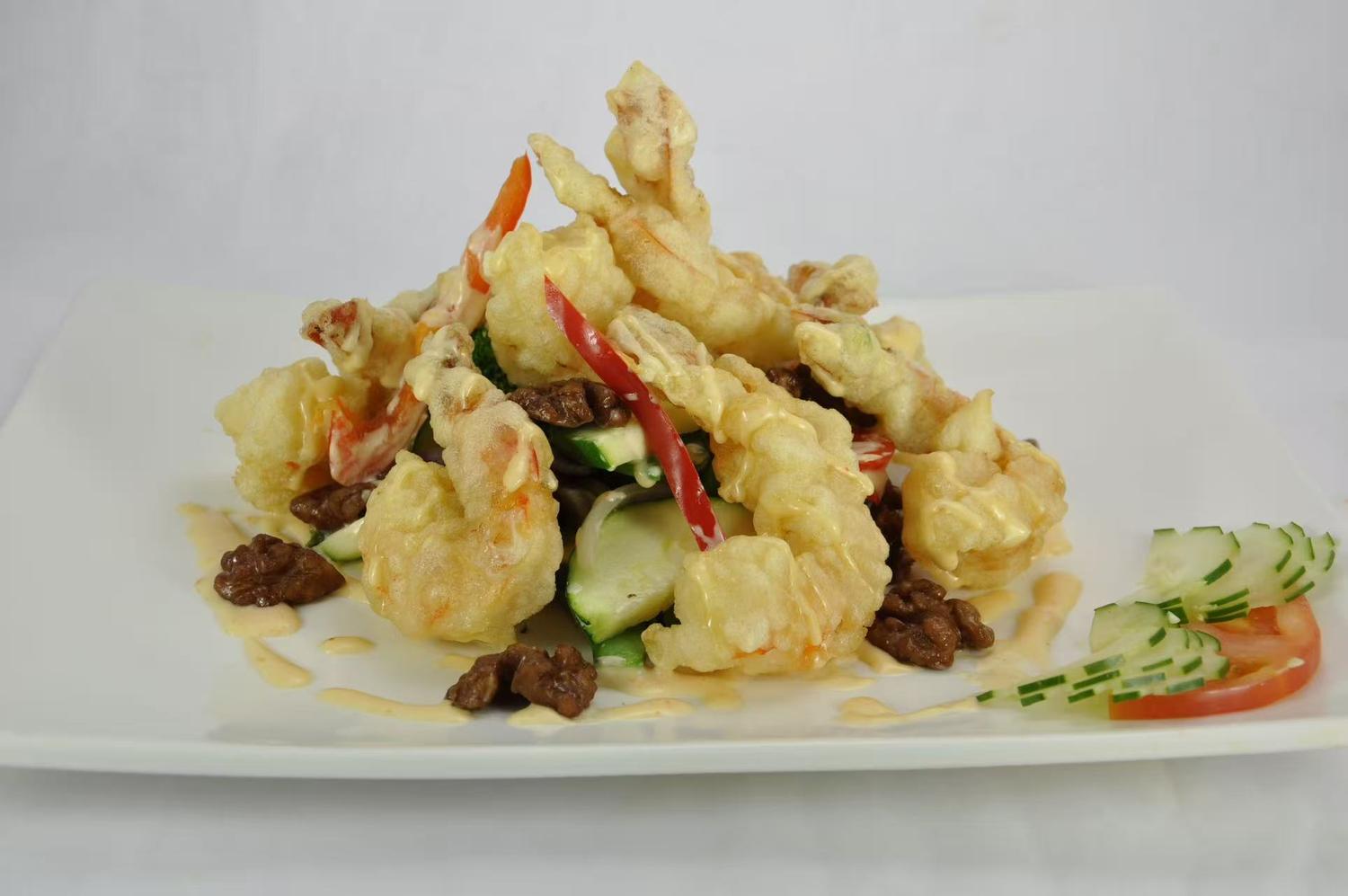 Crispy tempura shrimp on a bed of fresh salad.