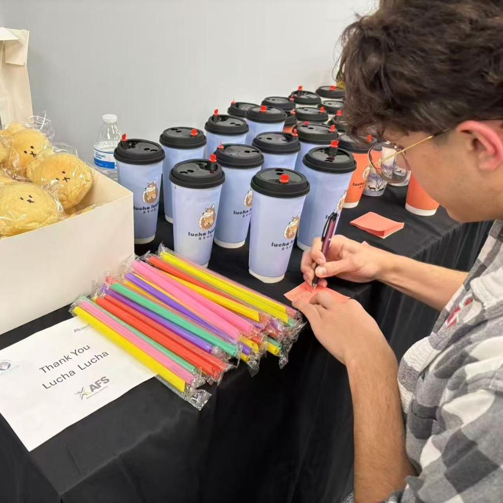 A man writes notes beside packaged straws and LuCha milk tea at LuCha Bubble Tea & Cafe, Bubble Tea Store in OH A man writes notes beside packaged straws and LuCha milk tea at LuCha Bubble Tea & Cafe, Bubble Tea Store in OH