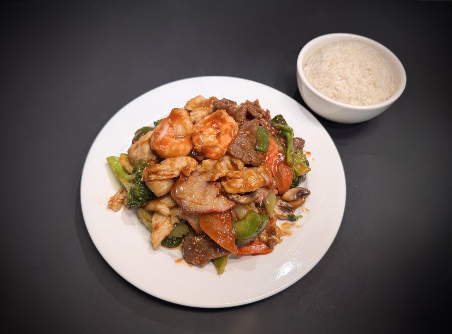 Combination stir‑fry with shrimp, chicken, pork and assorted vegetables with rice at Lucky House, a Chinese restaurant in Surprise