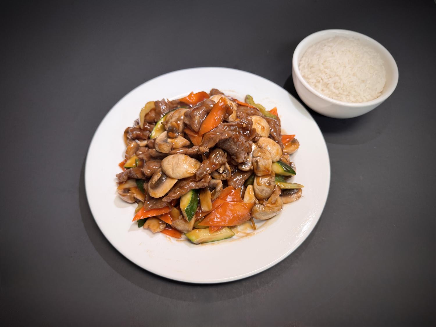 Beef mushroom stir‑fry with zucchini, carrots and steamed white rice at Lucky House, a Chinese restaurant in Surprise