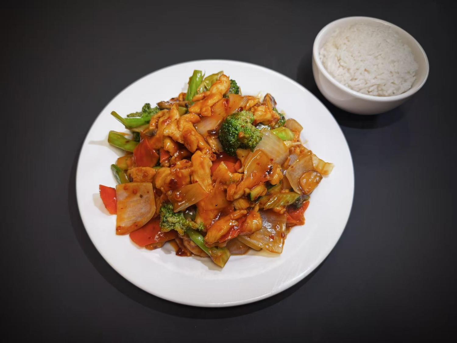 Spicy stir‑fried chicken with broccoli, onion and bell peppers served with steamed rice at Lucky House, a Chinese restaurant in Surprise