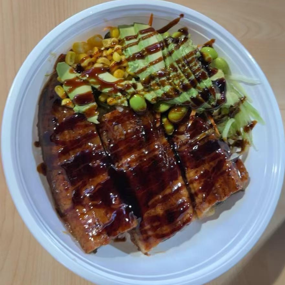 Bowl with grilled eel, avocado, corn, edamame, teriyaki sauce at Lucky Tacoshi, a Japanese Restaurant in West Covina